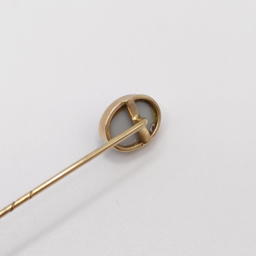 563 - A 20th century yellow metal and opal stick pin  Provenance:  From a single owner collection of Victo... 