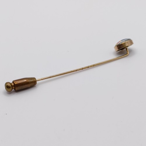 563 - A 20th century yellow metal and opal stick pin  Provenance:  From a single owner collection of Victo... 