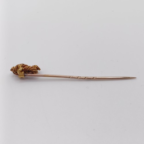 562 - A late 19th/early 20th century yellow metal stick pin, in the form of a knot Provenance:  From a sin... 