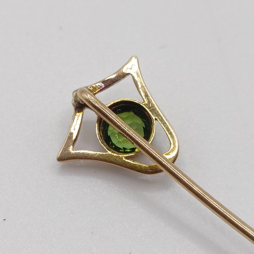 561 - A yellow metal and peridot stick pin  Provenance:  From a single owner collection of Victorian, Edwa... 