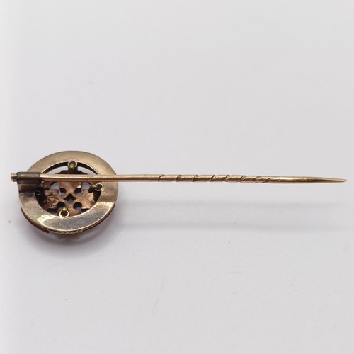 560 - A late 19th/early 20th century yellow coloured metal and hardstone stick pin, in the form of a Celti... 