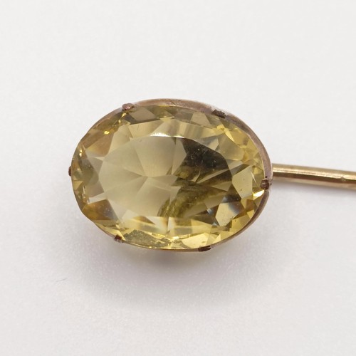 559 - A 20th century yellow metal and tanzanite stick pin  Provenance:  From a single owner collection of ... 