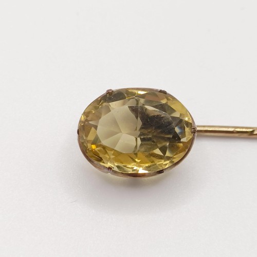 559 - A 20th century yellow metal and tanzanite stick pin  Provenance:  From a single owner collection of ... 