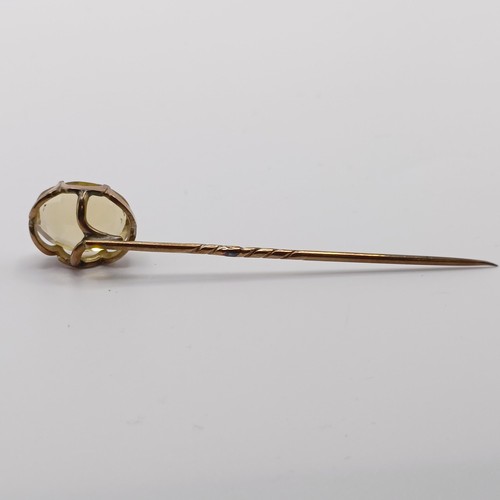 559 - A 20th century yellow metal and tanzanite stick pin  Provenance:  From a single owner collection of ... 