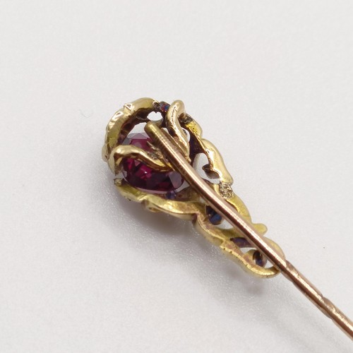 558 - A late 19th/early 20th century yellow metal and garnet stick pin   Provenance:  From a single owner ... 