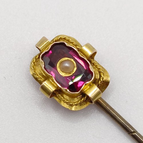 556 - A late 19th/early 20th century yellow metal, amethyst and seed pearl stick pin  Provenance:  From a ... 