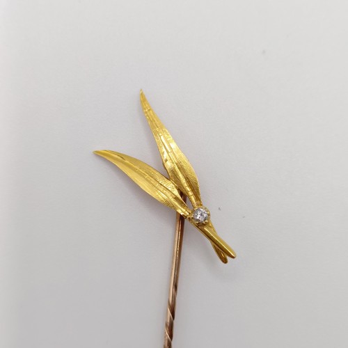 554 - A 20th century yellow metal and diamond stick pin, in the form of two feathers  Provenance:  From a ... 