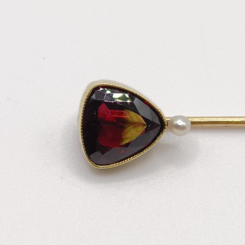 553 - A late 19th/early 20th century yellow metal, garnet and seed pearl stick pin  Provenance:  From a si... 