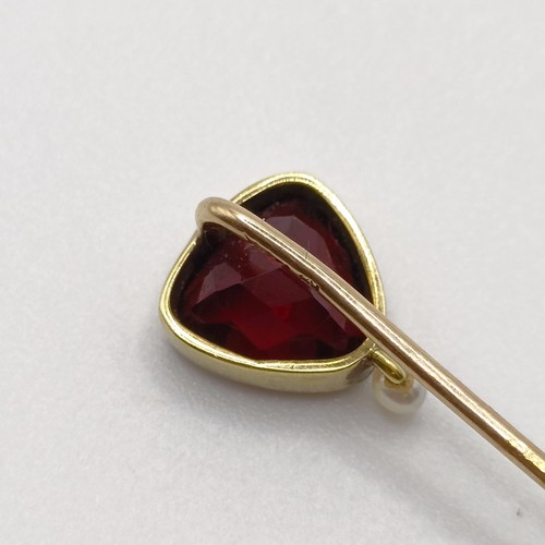 553 - A late 19th/early 20th century yellow metal, garnet and seed pearl stick pin  Provenance:  From a si... 