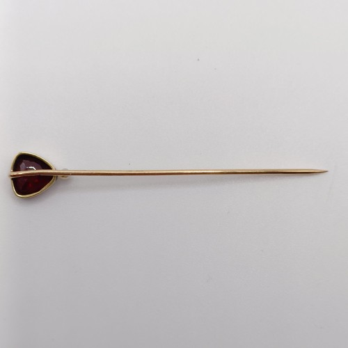 553 - A late 19th/early 20th century yellow metal, garnet and seed pearl stick pin  Provenance:  From a si... 