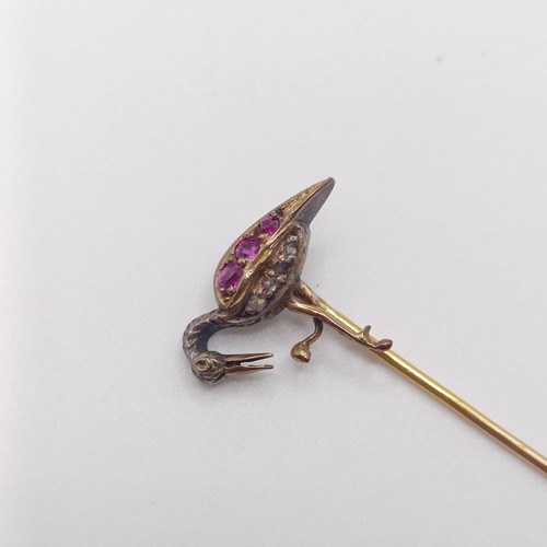 551 - A late 19th/early 20th century yellow metal, red and white stone stick pin, in the form of a bird  P... 