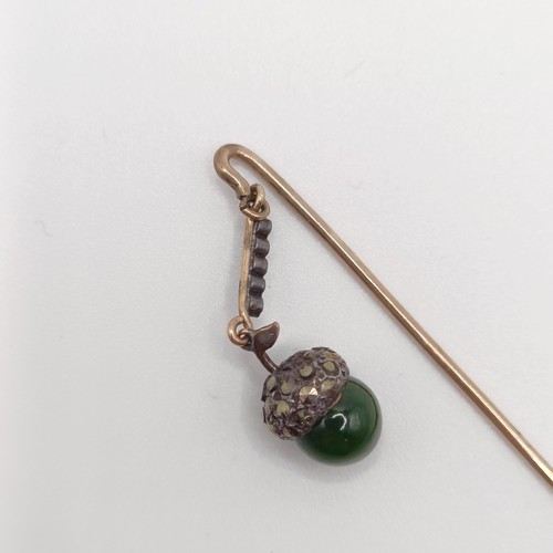 549 - A late 19th/early 20th century yellow metal white stone and green stone stick pin, in the form of an... 