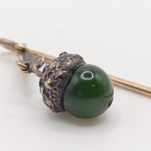 549 - A late 19th/early 20th century yellow metal white stone and green stone stick pin, in the form of an... 