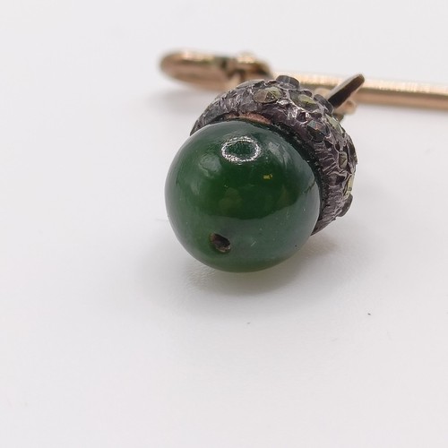 549 - A late 19th/early 20th century yellow metal white stone and green stone stick pin, in the form of an... 