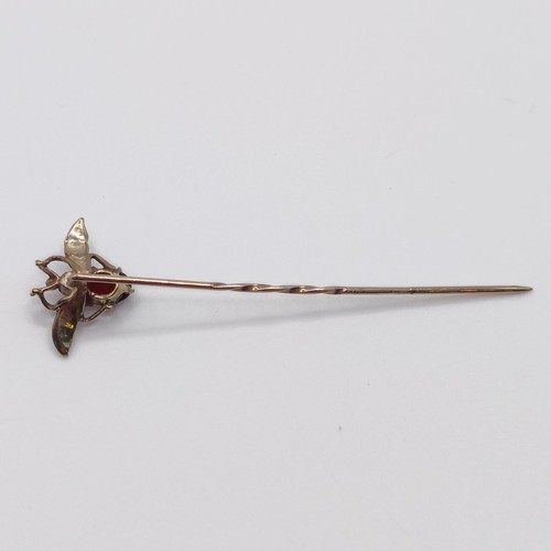 547 - A late 19th/early 20th century yellow metal red stone and seed pearl stick pin, in the form of a fly... 