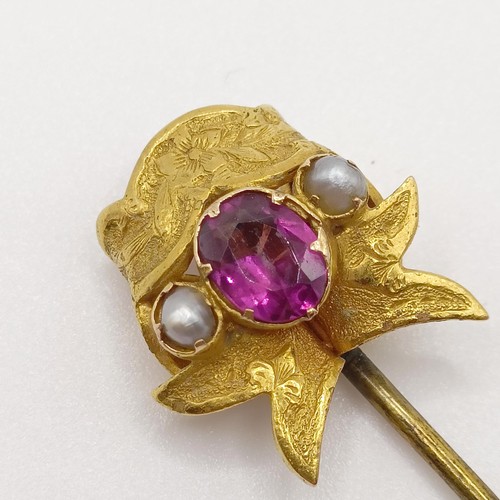 540 - An early 20th century yellow metal, pink stone and seed pearl stick pin  Provenance:  From a single ... 