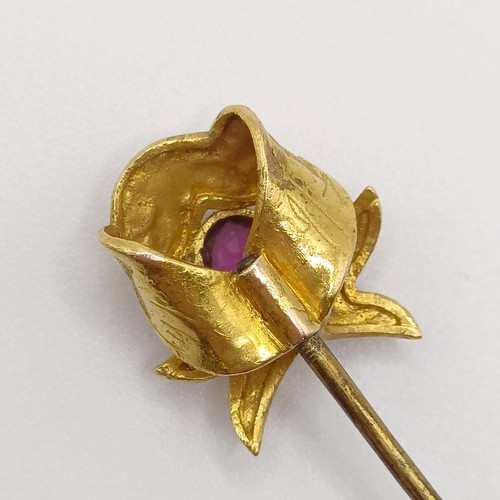 540 - An early 20th century yellow metal, pink stone and seed pearl stick pin  Provenance:  From a single ... 