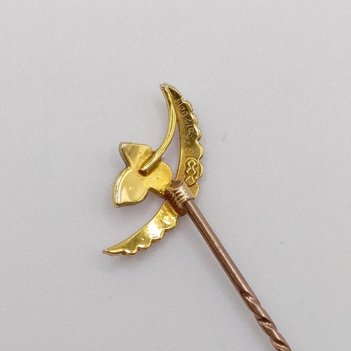 537 - An early 20th century yellow metal and seed pearl stick pin, in the form of a leaf and a cresent  Pr... 