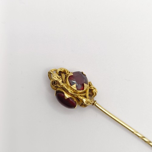 536 - A late 19th/early 20th century yellow metal and red stone stick pin  Provenance:  From a single owne... 