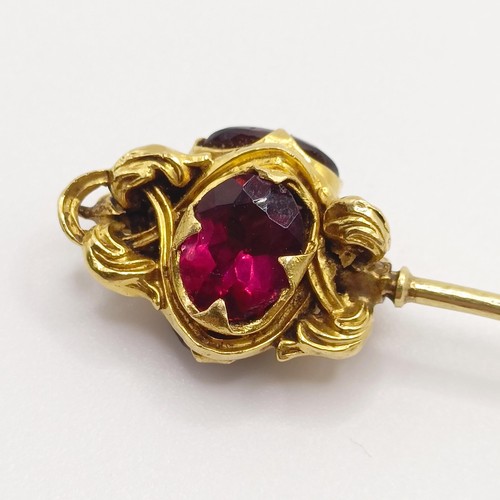 536 - A late 19th/early 20th century yellow metal and red stone stick pin  Provenance:  From a single owne... 