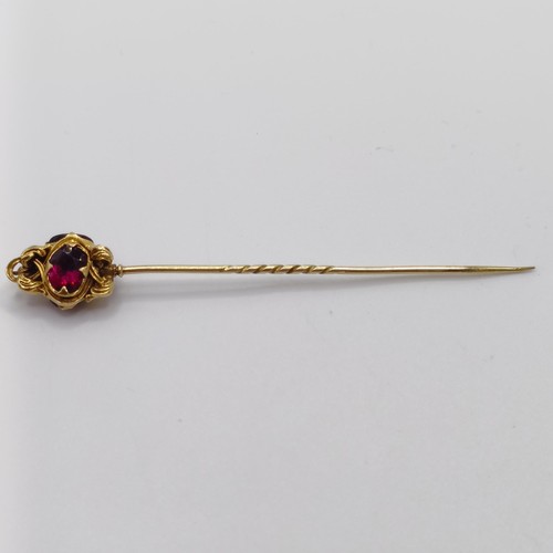 536 - A late 19th/early 20th century yellow metal and red stone stick pin  Provenance:  From a single owne... 