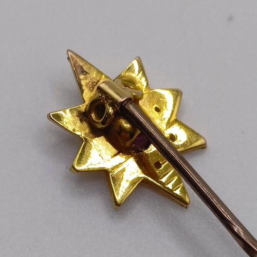 532 - An early 20th century silver coloured metal, yellow coloured metal, ruby and seed pearl stick pin  P... 