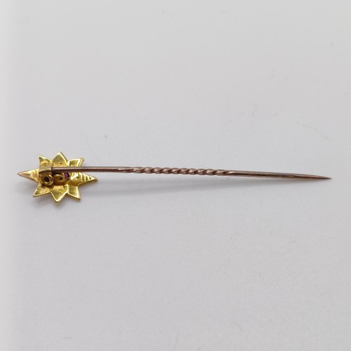 532 - An early 20th century silver coloured metal, yellow coloured metal, ruby and seed pearl stick pin  P... 