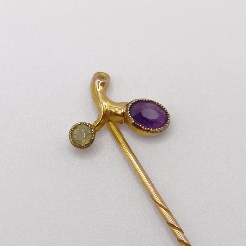 531 - A late 19th/early 20th century yellow metal, amethyst and peridot stick pin Provenance:  From a sing... 