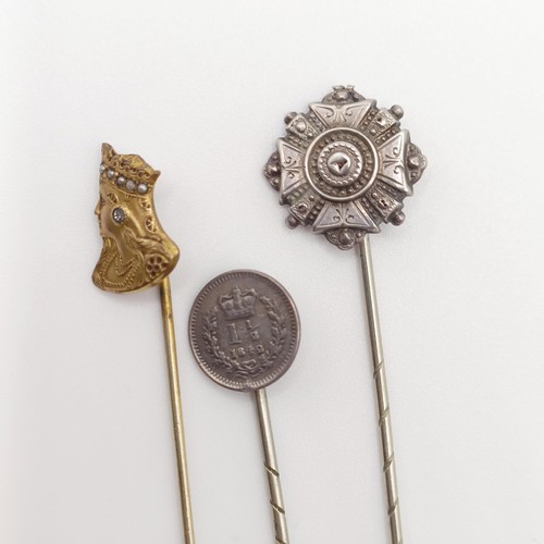 528 - A brass stick pin, in the form of a female bust, and two silver stick pins (3)  Provenance:  From a ... 