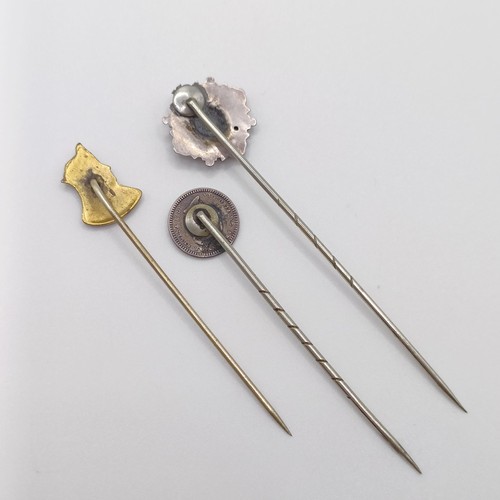 528 - A brass stick pin, in the form of a female bust, and two silver stick pins (3)  Provenance:  From a ... 