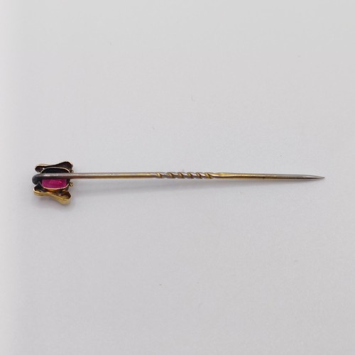 527 - A late 19th/early 20th century yellow metal and garnet stick pin  Provenance:  From a single owner c... 