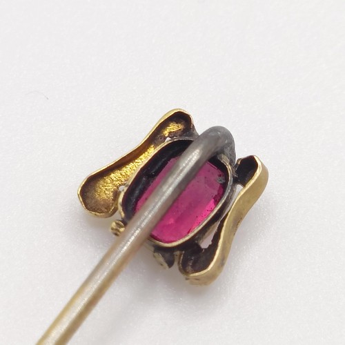 527 - A late 19th/early 20th century yellow metal and garnet stick pin  Provenance:  From a single owner c... 