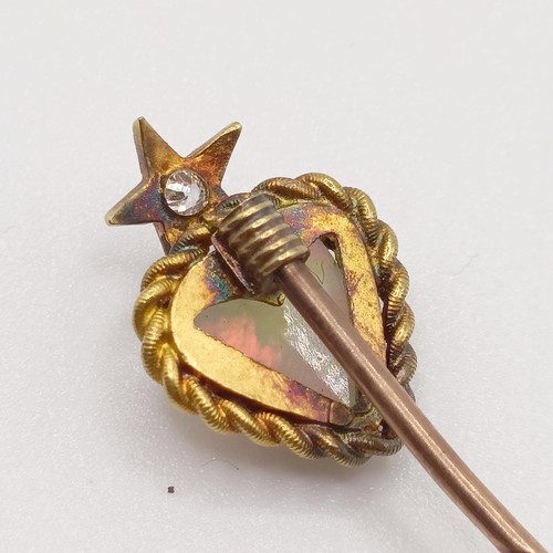 526 - A late 19th/early 20th century yellow metal, opal and diamond stick pin, in the form of a heart belo... 