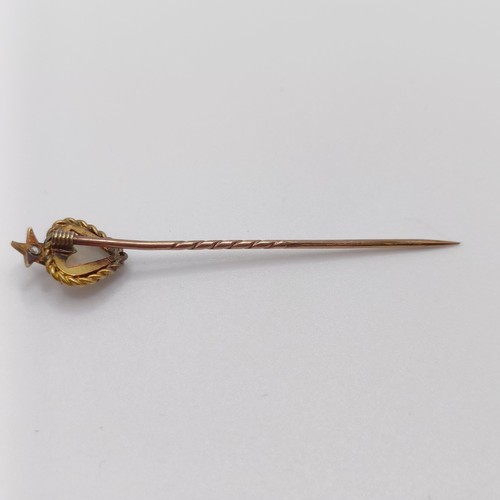 526 - A late 19th/early 20th century yellow metal, opal and diamond stick pin, in the form of a heart belo... 