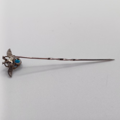 524 - A silver coloured metal, turquoise and seed pearl stick pin, in the form of a fly  Provenance:  From... 