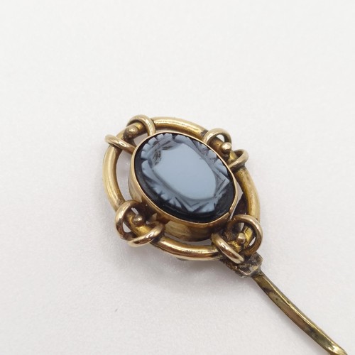 523 - A late 19th/early 20th century yellow metal and cameo glass stick pin  Provenance:  From a single ow... 