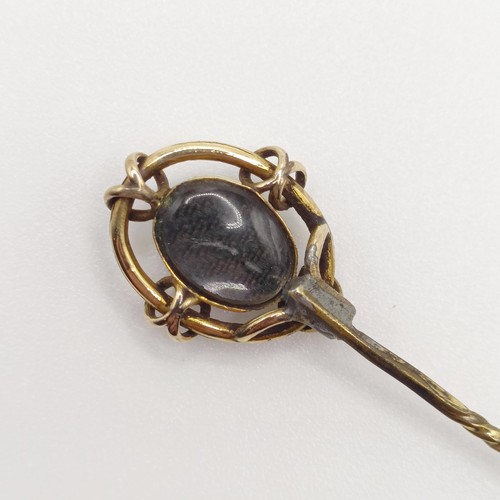 523 - A late 19th/early 20th century yellow metal and cameo glass stick pin  Provenance:  From a single ow... 