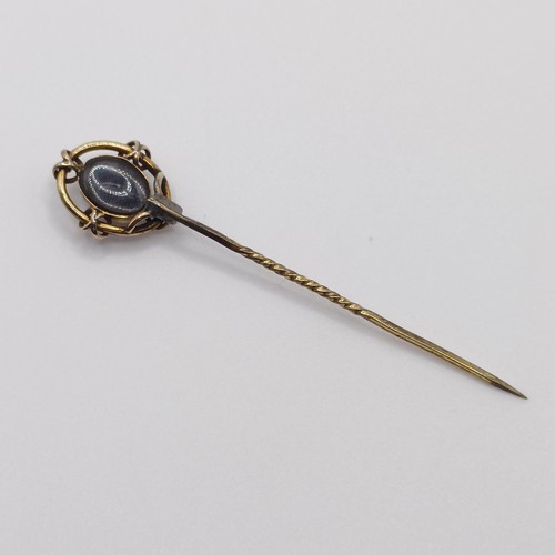 523 - A late 19th/early 20th century yellow metal and cameo glass stick pin  Provenance:  From a single ow... 