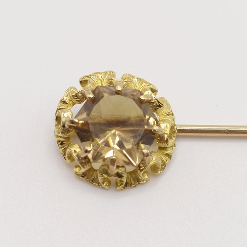 522 - A 20th century yellow metal and yellow stone stick pin Provenance:  From a single owner collection o... 