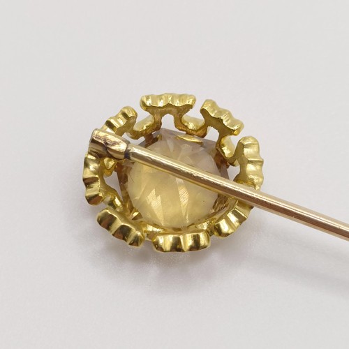 522 - A 20th century yellow metal and yellow stone stick pin Provenance:  From a single owner collection o... 