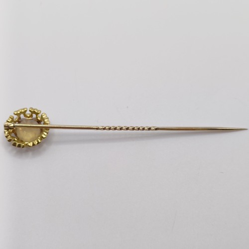 522 - A 20th century yellow metal and yellow stone stick pin Provenance:  From a single owner collection o... 