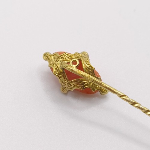 521 - A 20th century yellow metal, coral and white stone stick pin
Provenance:  From a single owner collec... 