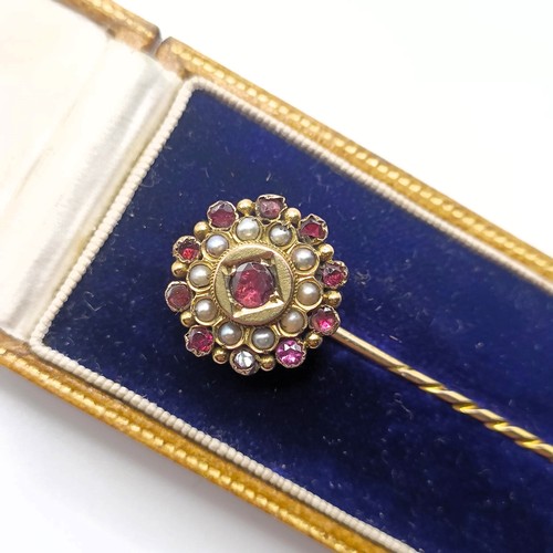 513 - A late 19th/early 20th century yellow metal, garnet and seed pearl stick pin, in a vintage jewellery... 