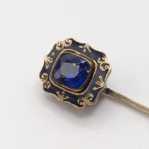 505 - A late 19th/early 20th century stick pin, a blue stone surrounded by an enamel and seed pearl mount,... 