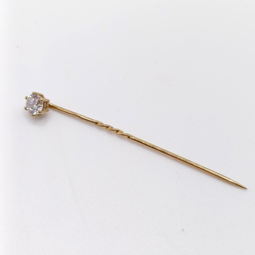 661 - A 20th century yellow coloured metal and diamond solitaire stick pin Provenance:  From a single owne... 