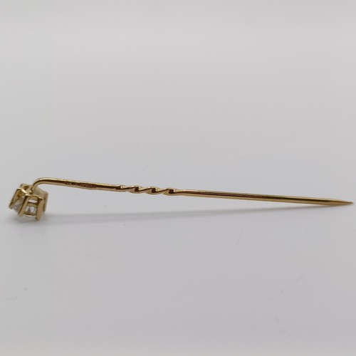 661 - A 20th century yellow coloured metal and diamond solitaire stick pin Provenance:  From a single owne... 