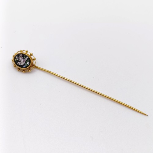 660 - A late 19th/early 20th century yellow metal stick pin, inset with micro-mosaic panel, decorated dove... 