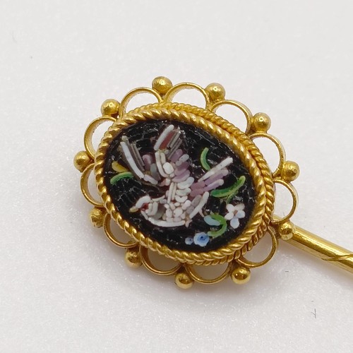 660 - A late 19th/early 20th century yellow metal stick pin, inset with micro-mosaic panel, decorated dove... 