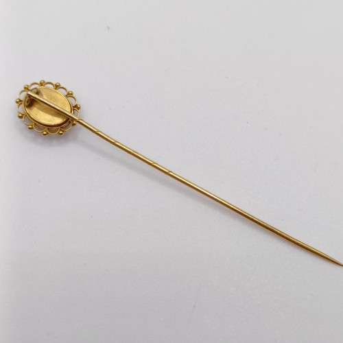 660 - A late 19th/early 20th century yellow metal stick pin, inset with micro-mosaic panel, decorated dove... 