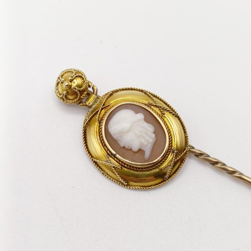 655 - A 19th century yellow coloured metal and glass cameo stick pin, decorated portrait of a man   Proven... 